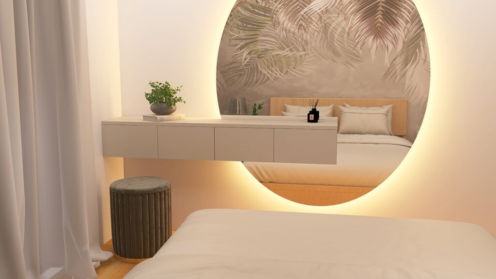 Wnętrze pokoju z dużym, dekoracyjnym lustrem, miękkim łóżkiem i nowoczesnymi dodatkami, co tworzy elegancką atmosferę relaksu.